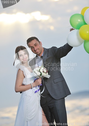 Image of romantic beach wedding at sunset