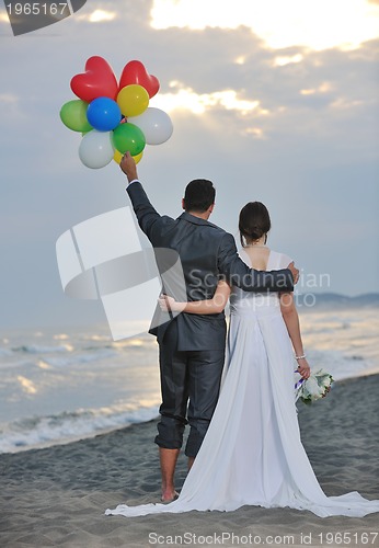 Image of romantic beach wedding at sunset