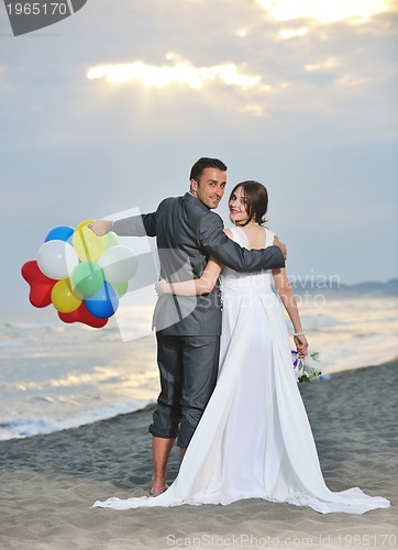 Image of romantic beach wedding at sunset