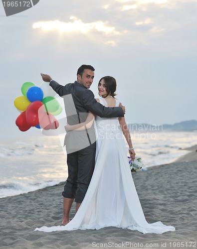 Image of romantic beach wedding at sunset