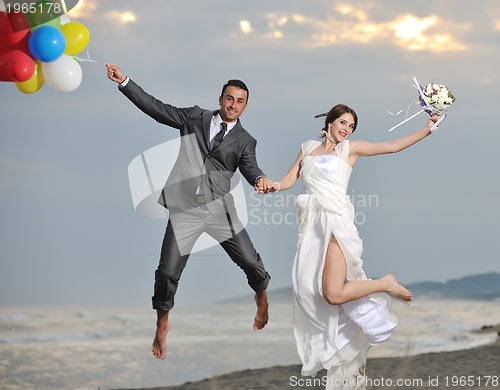 Image of romantic beach wedding at sunset