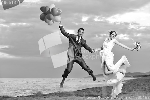 Image of romantic beach wedding at sunset