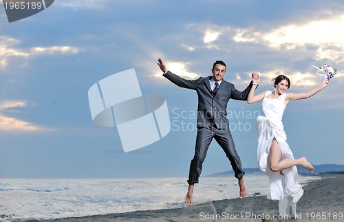 Image of romantic beach wedding at sunset