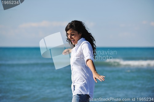 Image of happy young woman on beach