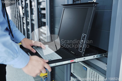 Image of young it engineer in datacenter server room