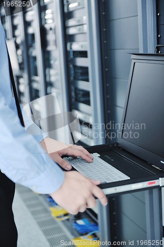 Image of young it engineer in datacenter server room