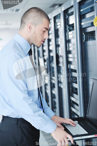 Image of young it engineer in datacenter server room