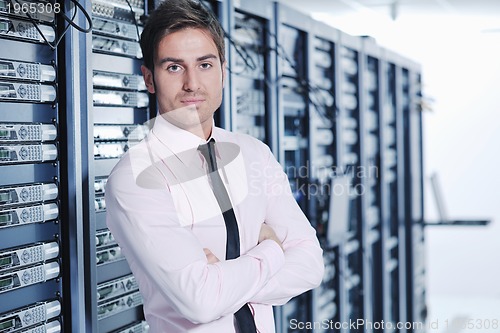 Image of young it engeneer in datacenter server room