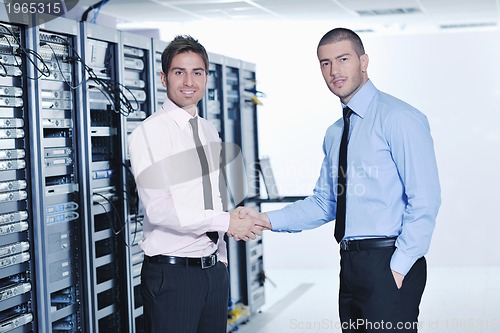 Image of it engineers in network server room