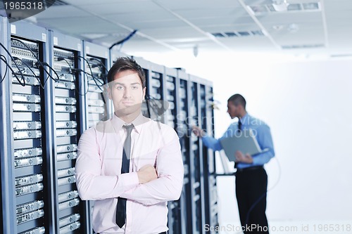 Image of it engineers in network server room