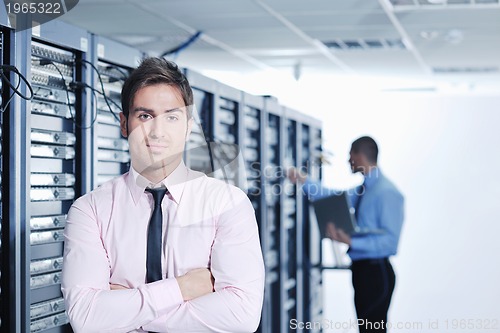 Image of it engineers in network server room