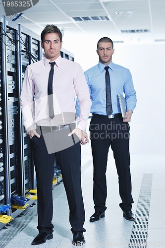 Image of it engineers in network server room