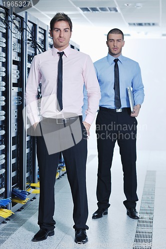 Image of it engineers in network server room