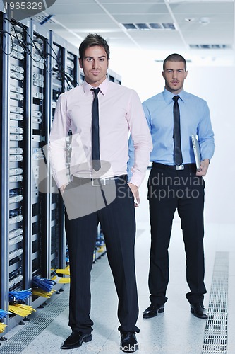 Image of it engineers in network server room