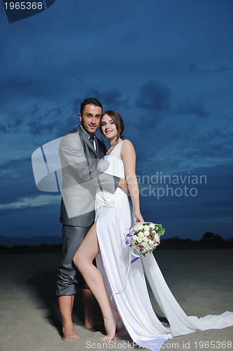 Image of romantic beach wedding at sunset