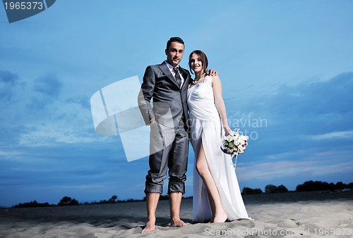 Image of romantic beach wedding at sunset