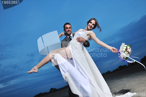 Image of romantic beach wedding at sunset