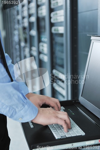 Image of young it engeneer in datacenter server room