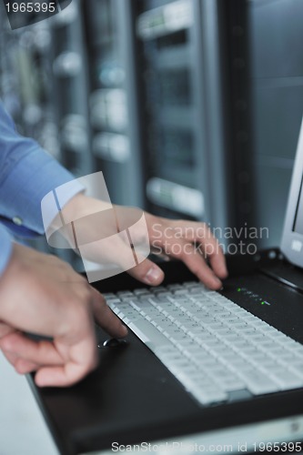 Image of young it engeneer in datacenter server room