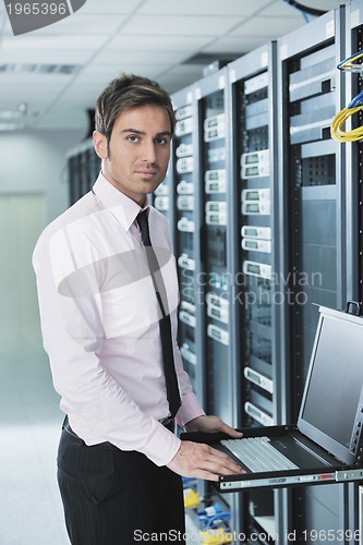 Image of young it engeneer in datacenter server room