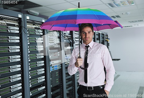 Image of businessman hold umbrella in server room