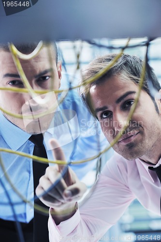 Image of it engineers in network server room