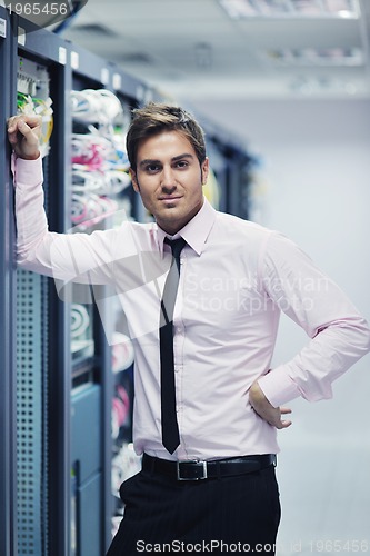 Image of young it engeneer in datacenter server room