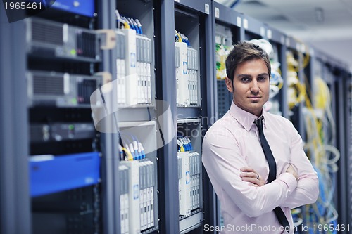 Image of young it engeneer in datacenter server room