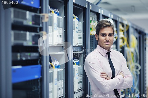 Image of young it engeneer in datacenter server room