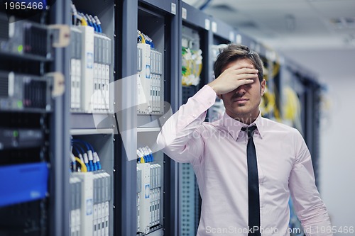 Image of young it engeneer in datacenter server room