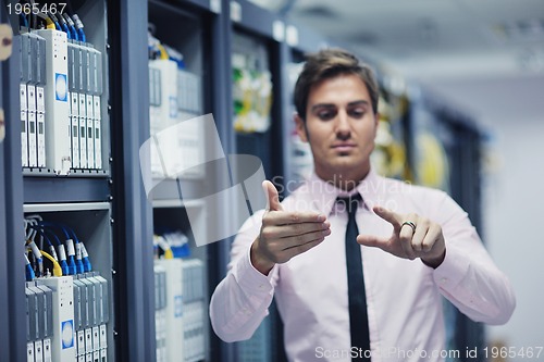 Image of young it engeneer in datacenter server room