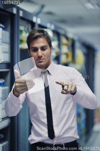 Image of young it engeneer in datacenter server room