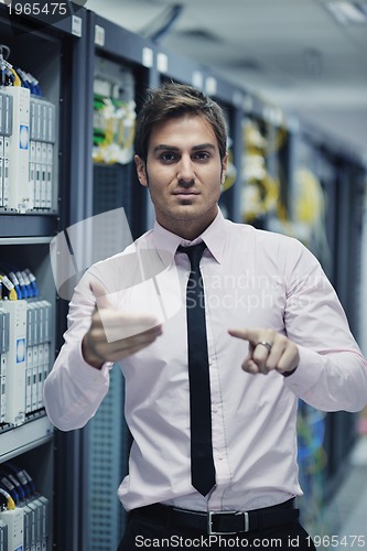 Image of young it engeneer in datacenter server room