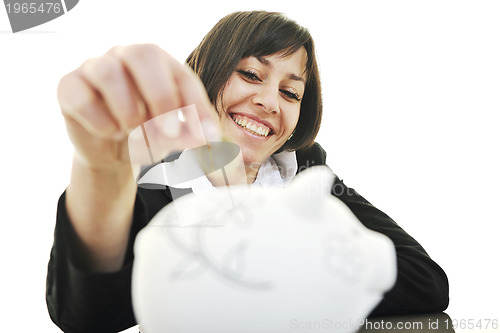 Image of business woman putting coins money in piggy bank