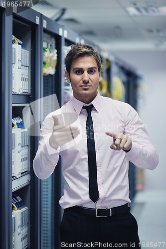 Image of young it engeneer in datacenter server room