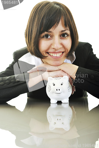 Image of business woman putting coins money in piggy bank