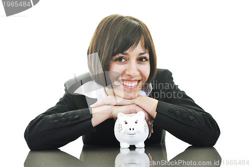 Image of business woman putting coins money in piggy bank