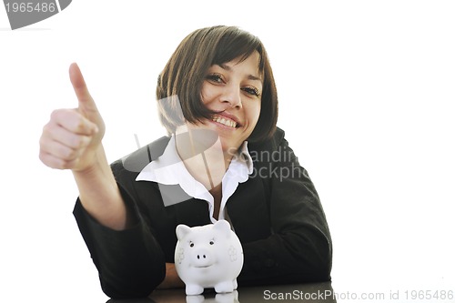 Image of business woman putting coins money in piggy bank