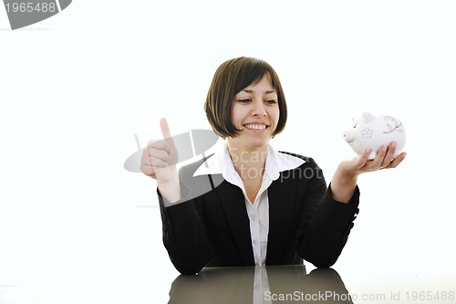 Image of business woman putting coins money in piggy bank