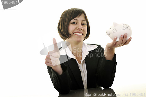 Image of business woman putting coins money in piggy bank