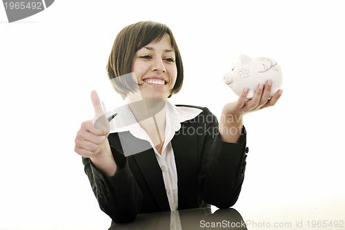 Image of business woman putting coins money in piggy bank