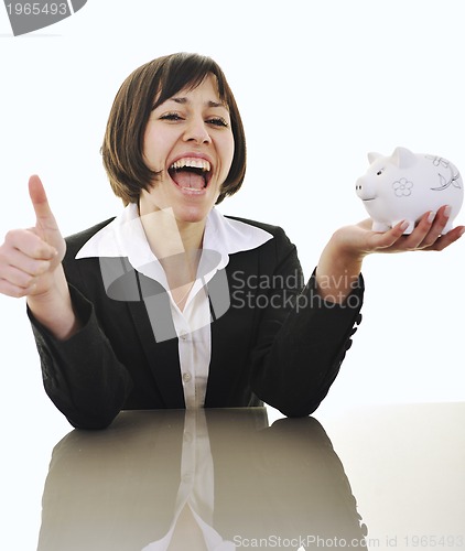 Image of business woman putting coins money in piggy bank