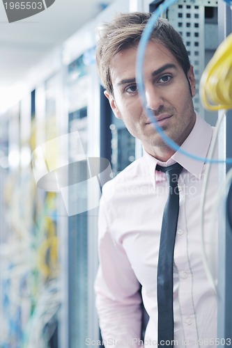 Image of young it engeneer in datacenter server room