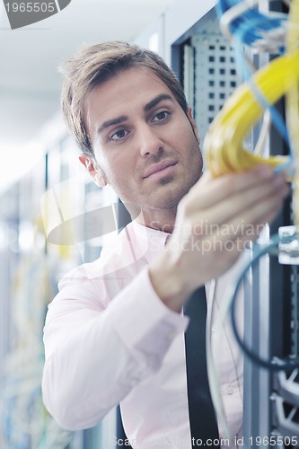 Image of young it engeneer in datacenter server room