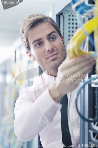 Image of young it engeneer in datacenter server room