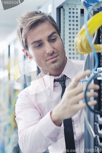 Image of young it engeneer in datacenter server room