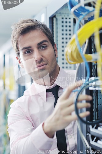 Image of young it engeneer in datacenter server room