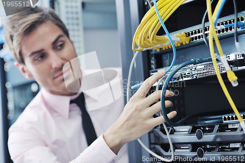 Image of young it engineer in datacenter server room