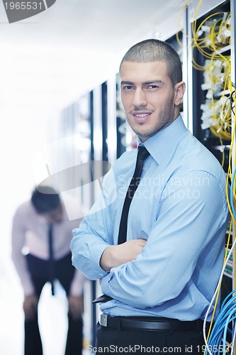 Image of it engineers in network server room