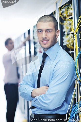 Image of it engineers in network server room